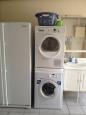 The laundry room with washing machine and tumble dryer