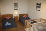 A second twin bedroom with cot
